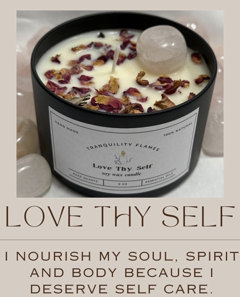 Candle with crystal and rose petals on top.